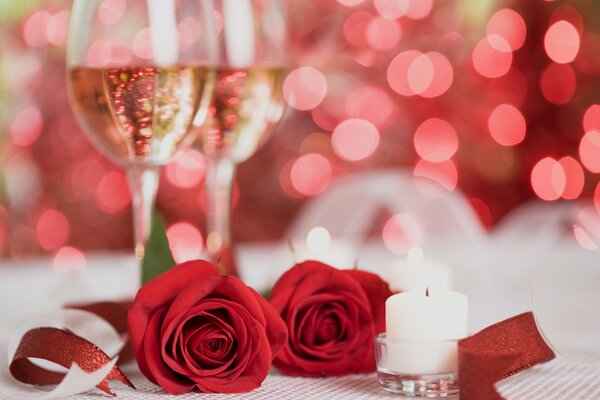 Red roses and sparkling champagne in glasses