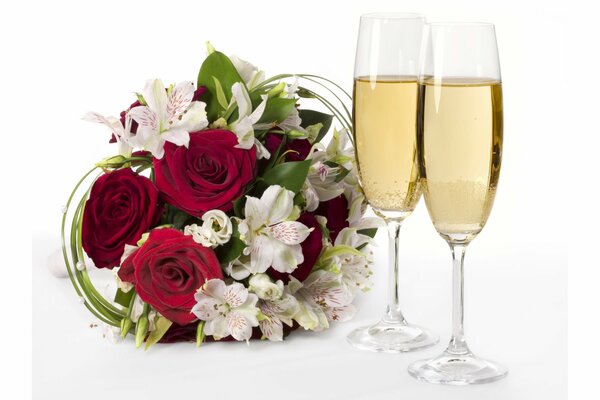 A bouquet of flowers and two glasses of champagne