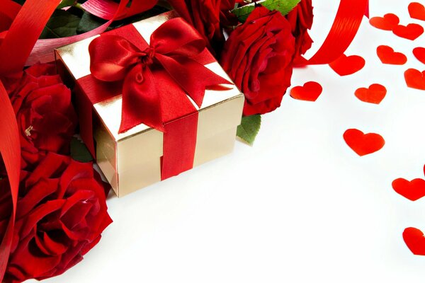 Pudełko z prezentem otoczone różami i sercami