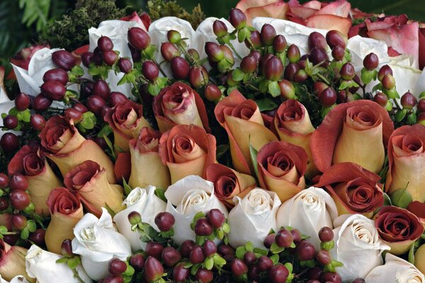 Composition of white and tea roses with berries