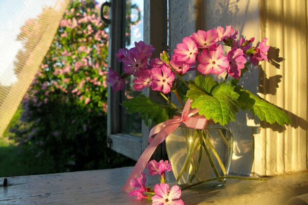 Bouquet of summer flowers on the windowsill