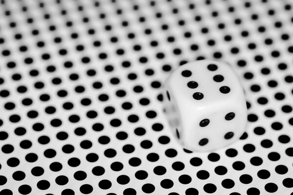 Game white cube on a white background with a black dot