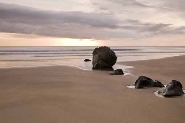 Sunset on a sandy sea beach