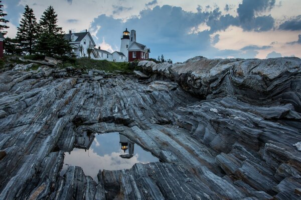 House on the rocks. Reflection in water