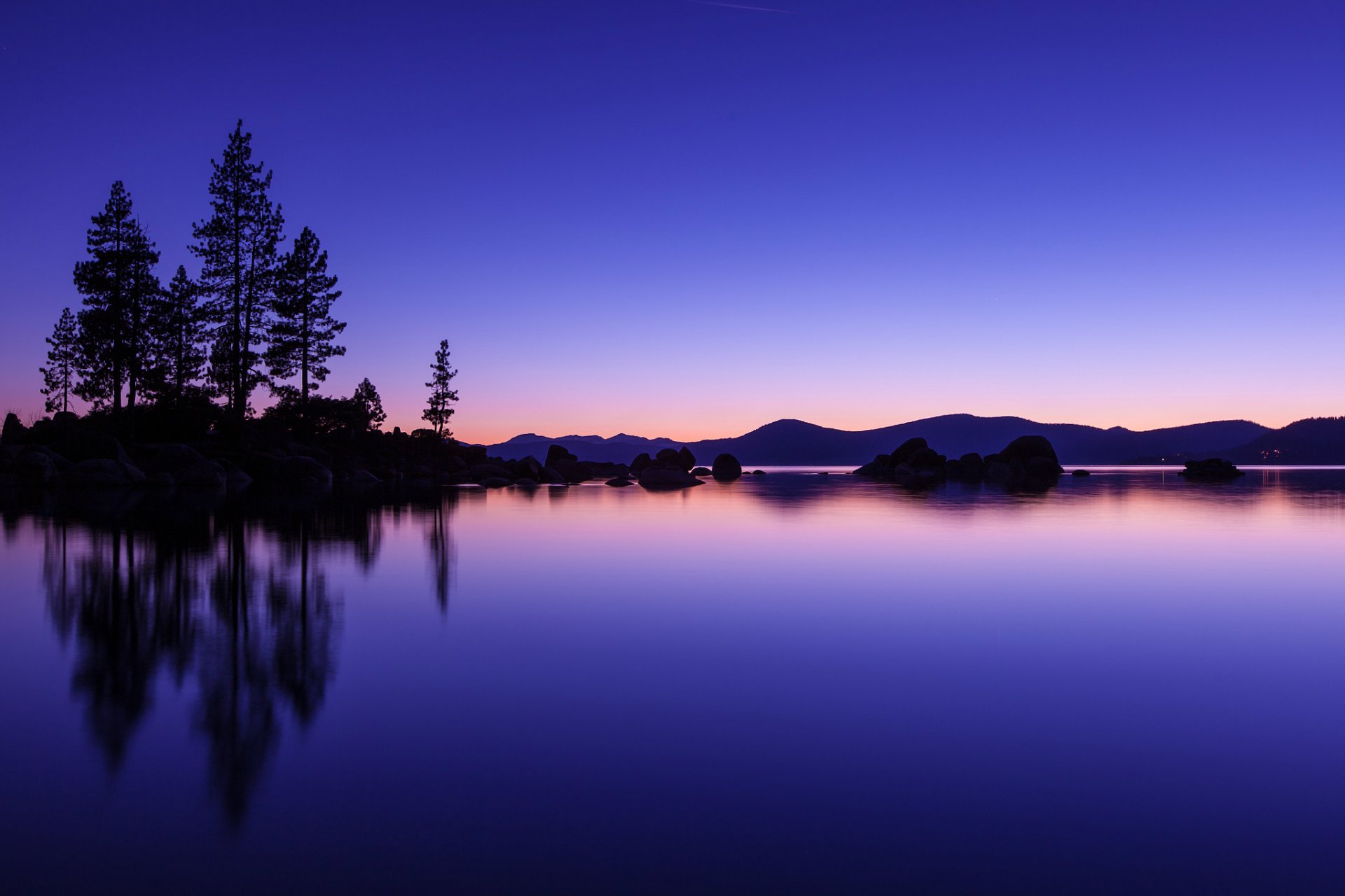 united states lake water surface of reflection beach tree hills night orange sunset sky blue