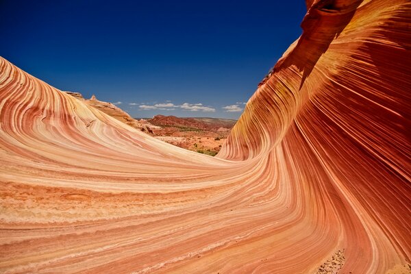 On the background of the sky is a red rock with a striped texture