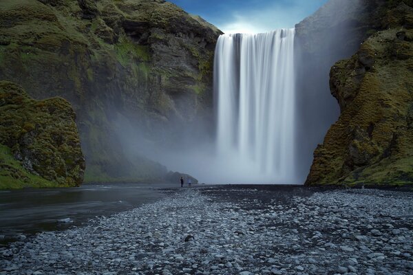 A smooth white waterfall among the rocks