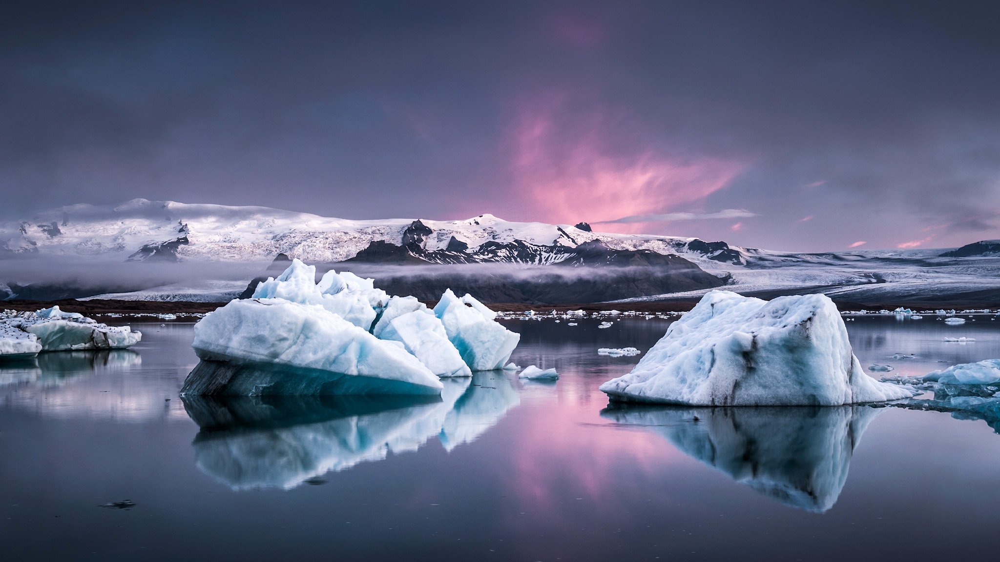 ice floes sea lumps rock snow clouds fog glow