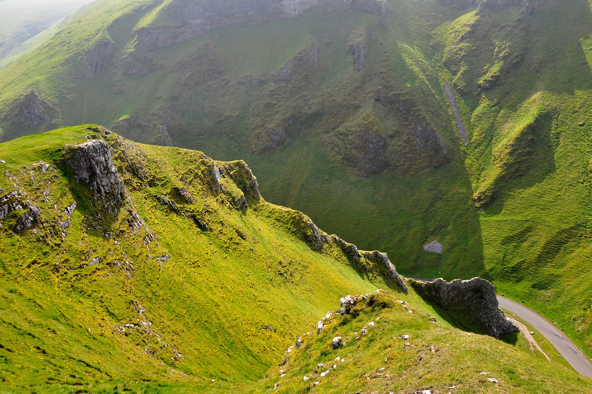 nature slopes rock hills mountain grass green road