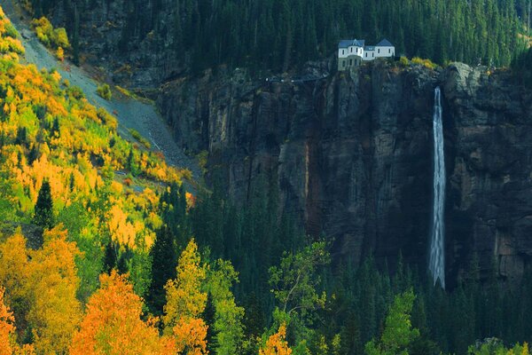 Cascada de montaña. Casa en las rocas