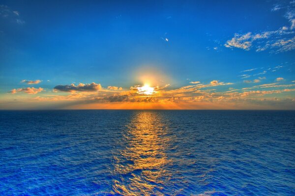 The blue sea in the rays of sunset