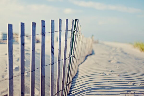 Winter road along the fence