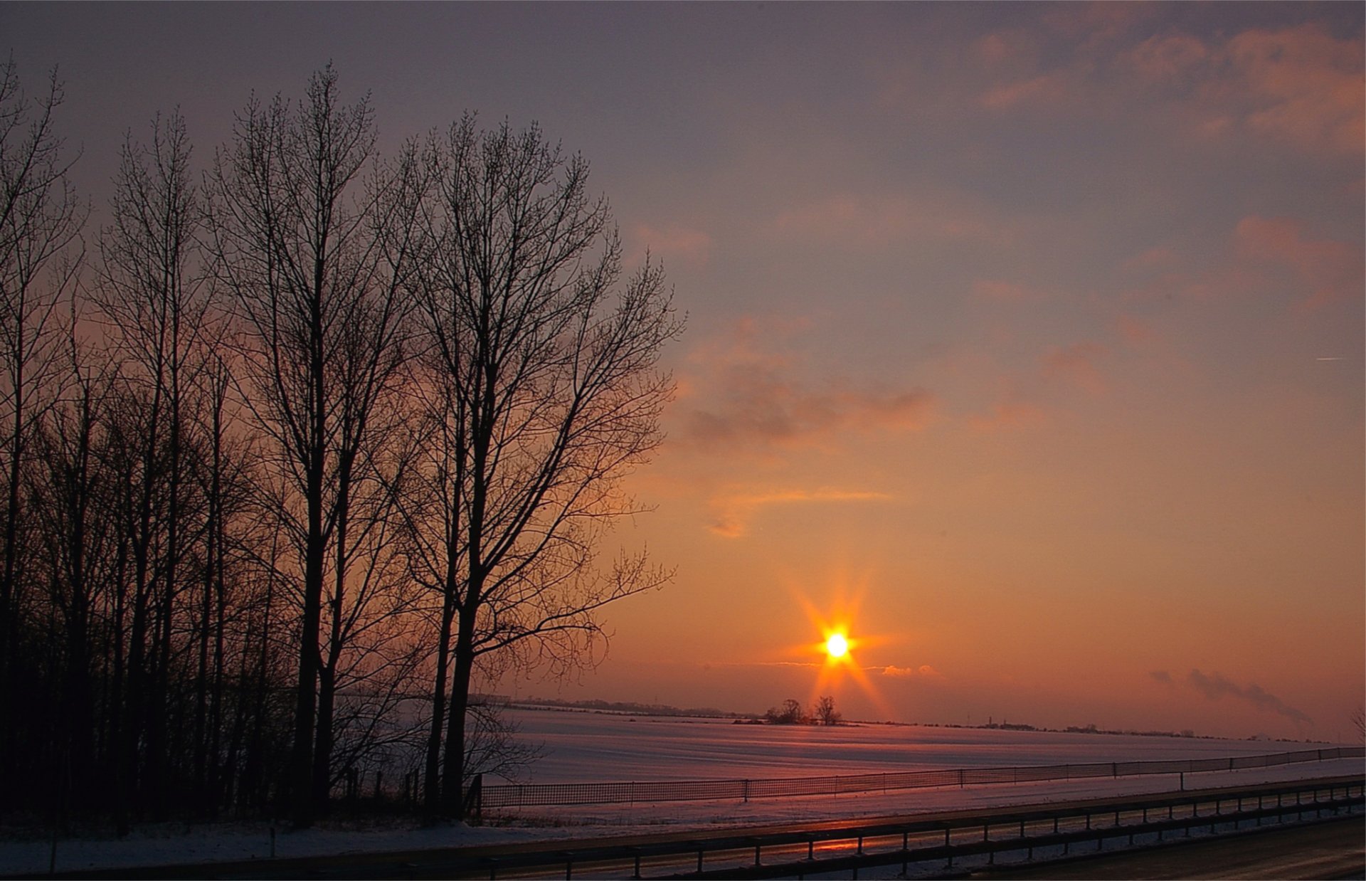 winter snow night orange sunset sun rays sky clouds the field tree road track