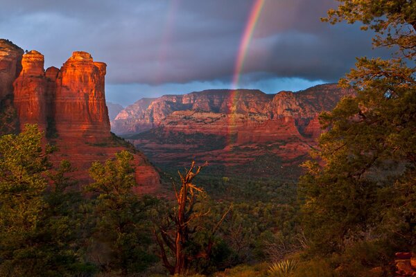 Double rainbow among high mountains