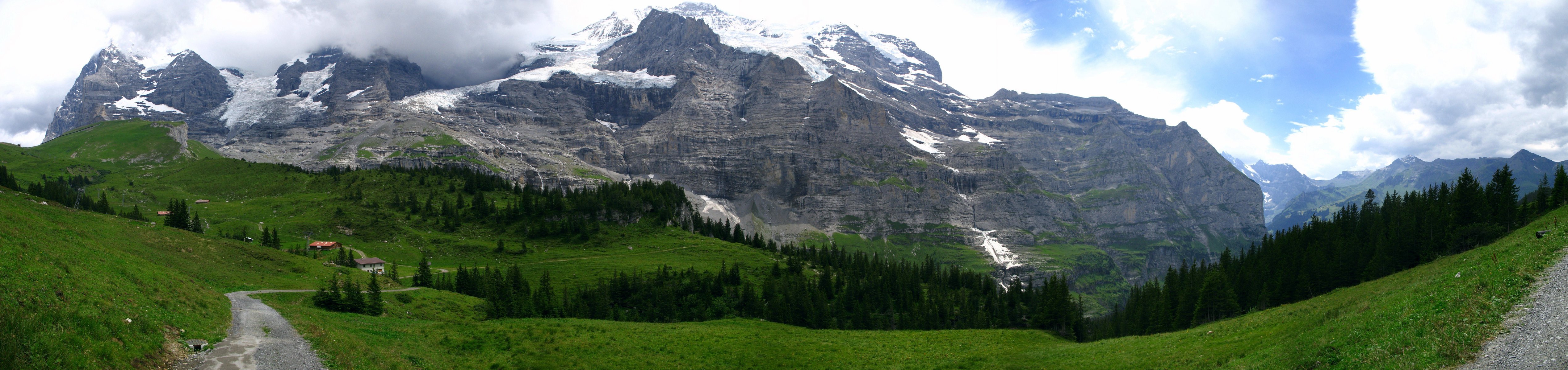 landscape mountain summit snow panorama valley field meadow grass forest tree road nature photo sky cloud