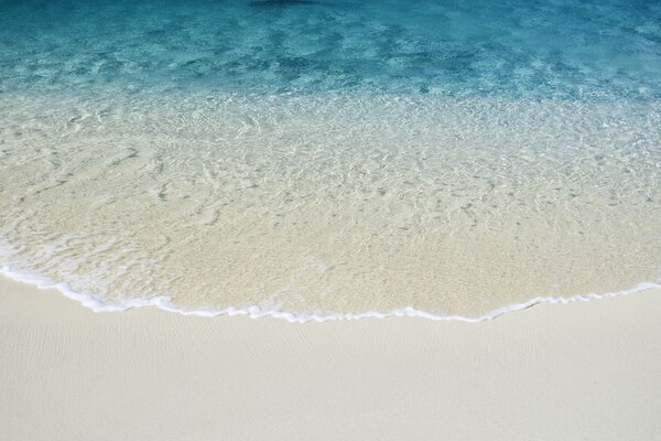 Sand at the beach with clear water