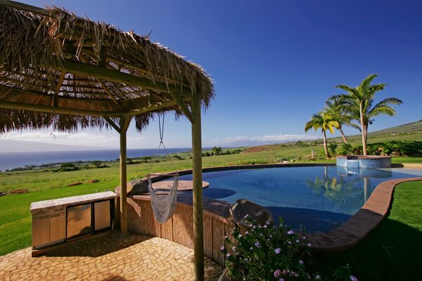 OUTDOOR RECREATION BY THE POOL WITH A BEAUTIFUL LANDSCAPE