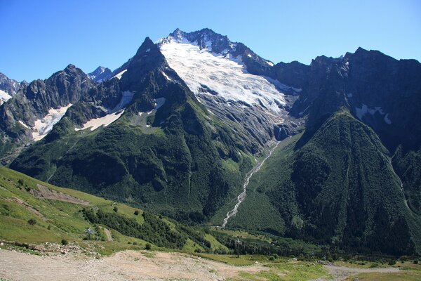 Mountain peaks in places in the snow from the side