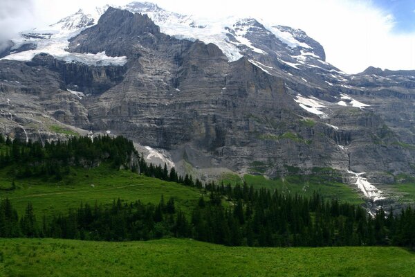 Snowy mountains under a cloudy sky