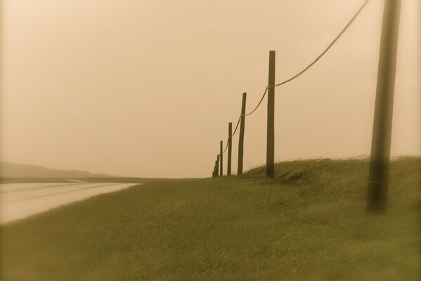 Pillars on the evening road in the field