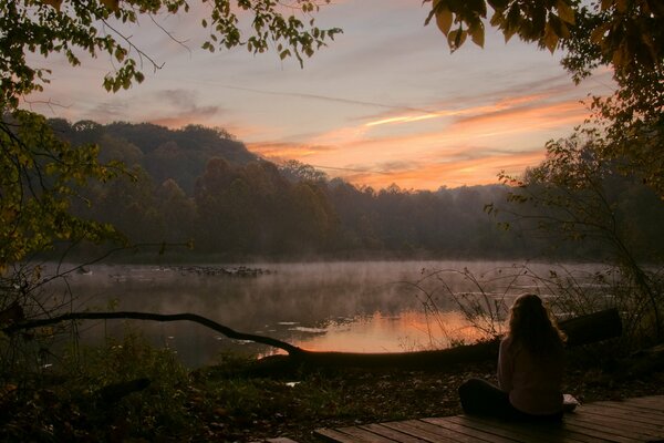 Chica en el lago por la mañana amanecer