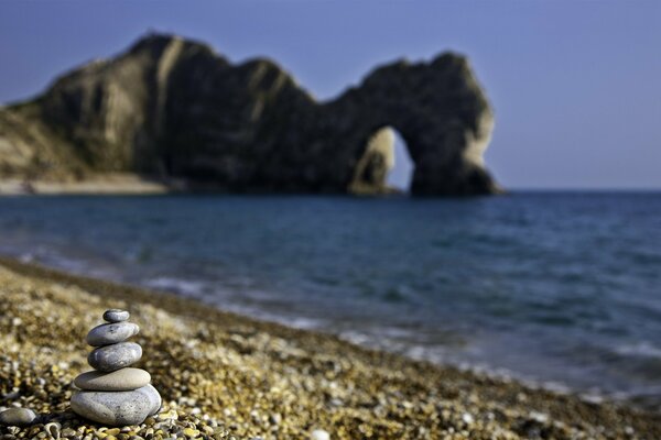 Rocks on the beach against the background of mountains