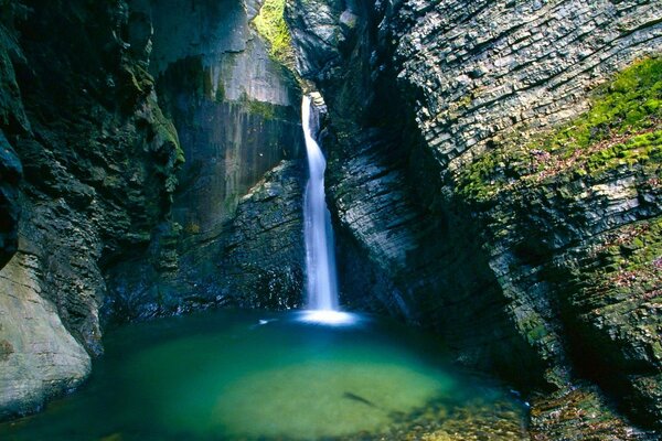 Una cascada brillante gotea de las rocas