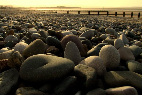 Rocks near the sand. Bridge over the sandy wasteland