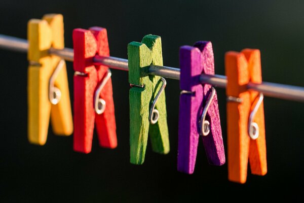 Colorful clothespins hanging on a rope