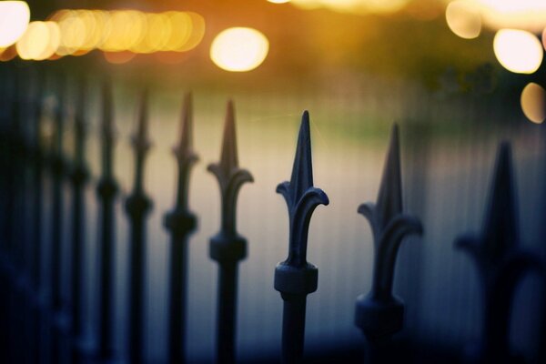 Black fence. Macro shooting on the background of lights