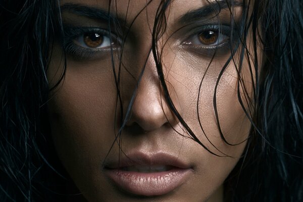 Chica con ojos marrones, cabello oscuro, mirada misteriosa