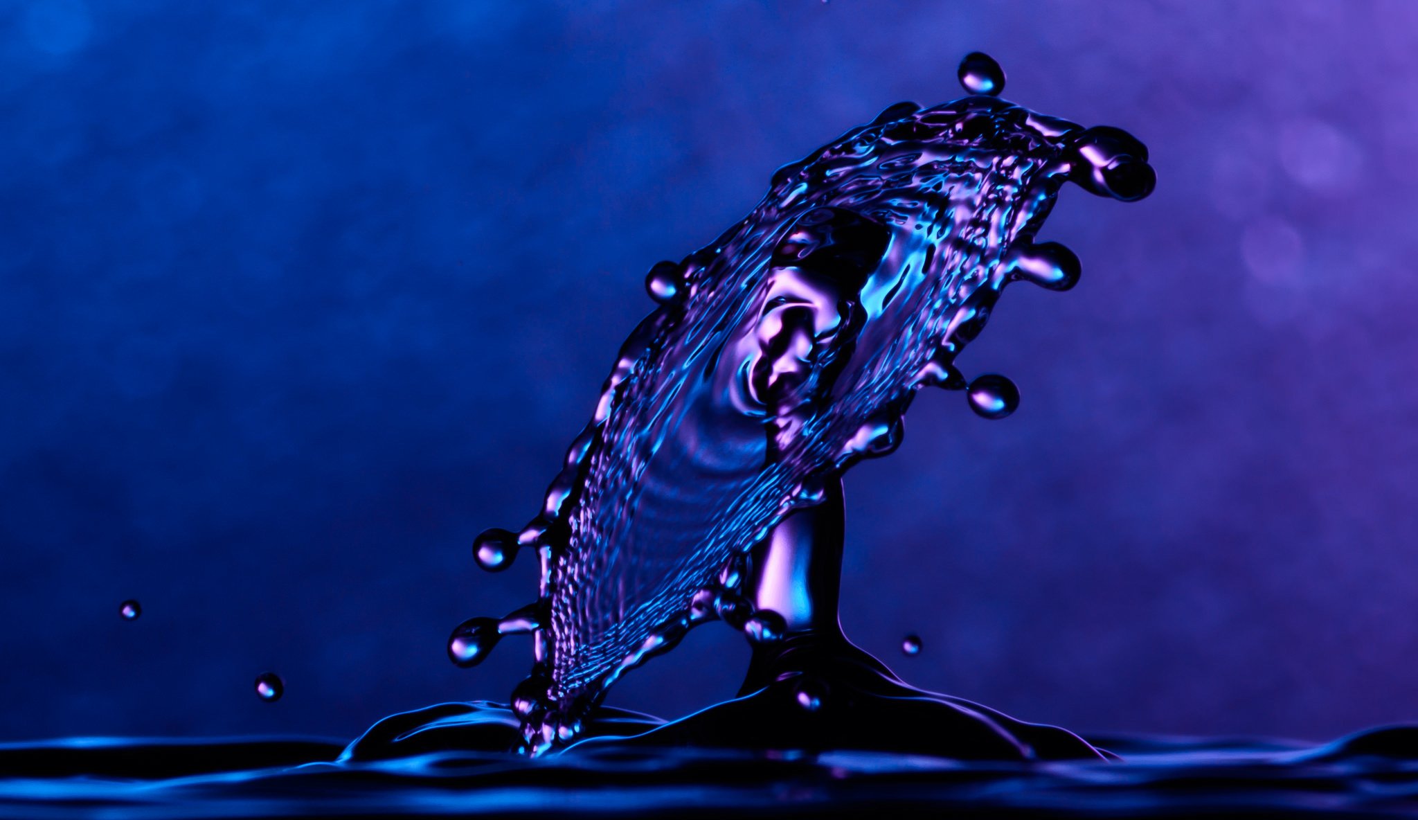 water spray bulka splash droplets blue background close up