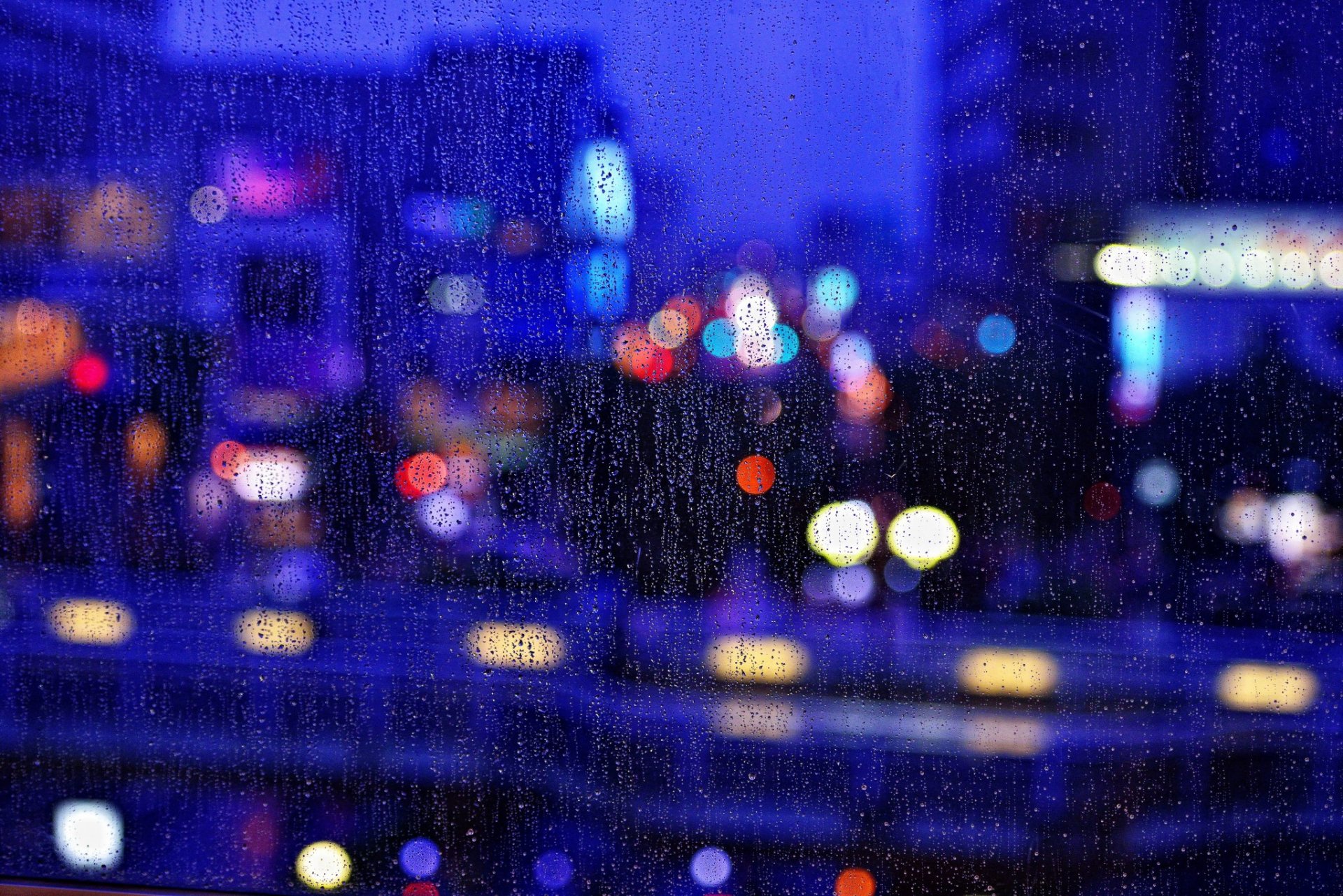 close up window rain night town