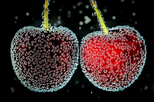 Ripe cherries in bubbles in water
