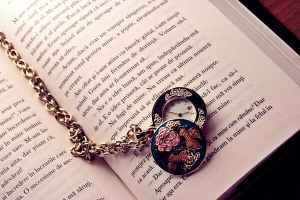 Watch on a chain on a book page