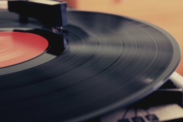 The vinyl record is delivered in a gramophone