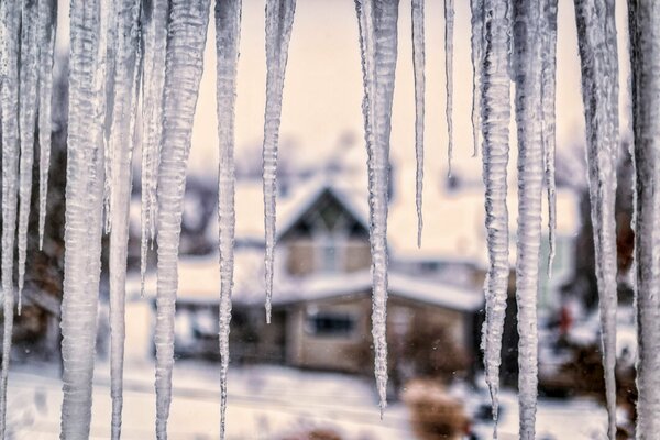 Icicles on the background of village houses