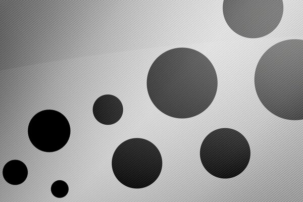 Cerchi neri di diverse dimensioni su sfondo bianco