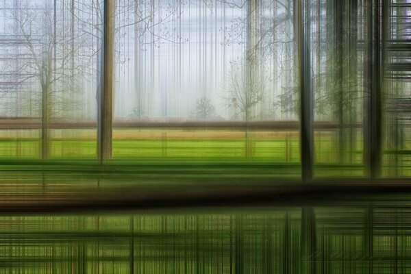 Abstrakter Blick auf grünes Feld und Bäume in Bewegung