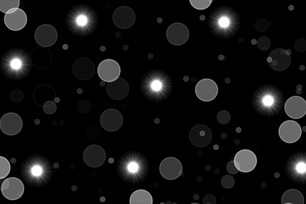 Shining circles of light on a black background