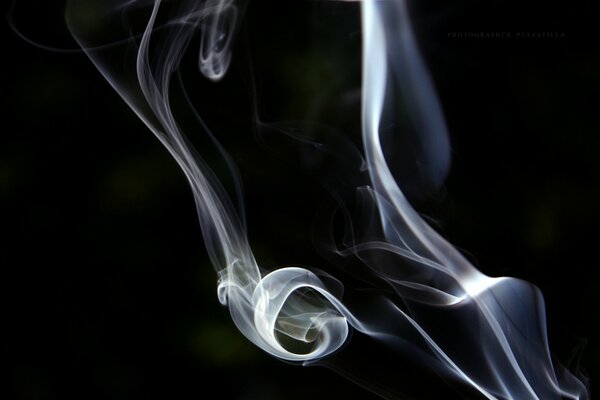 Blue-white smoke on a black background