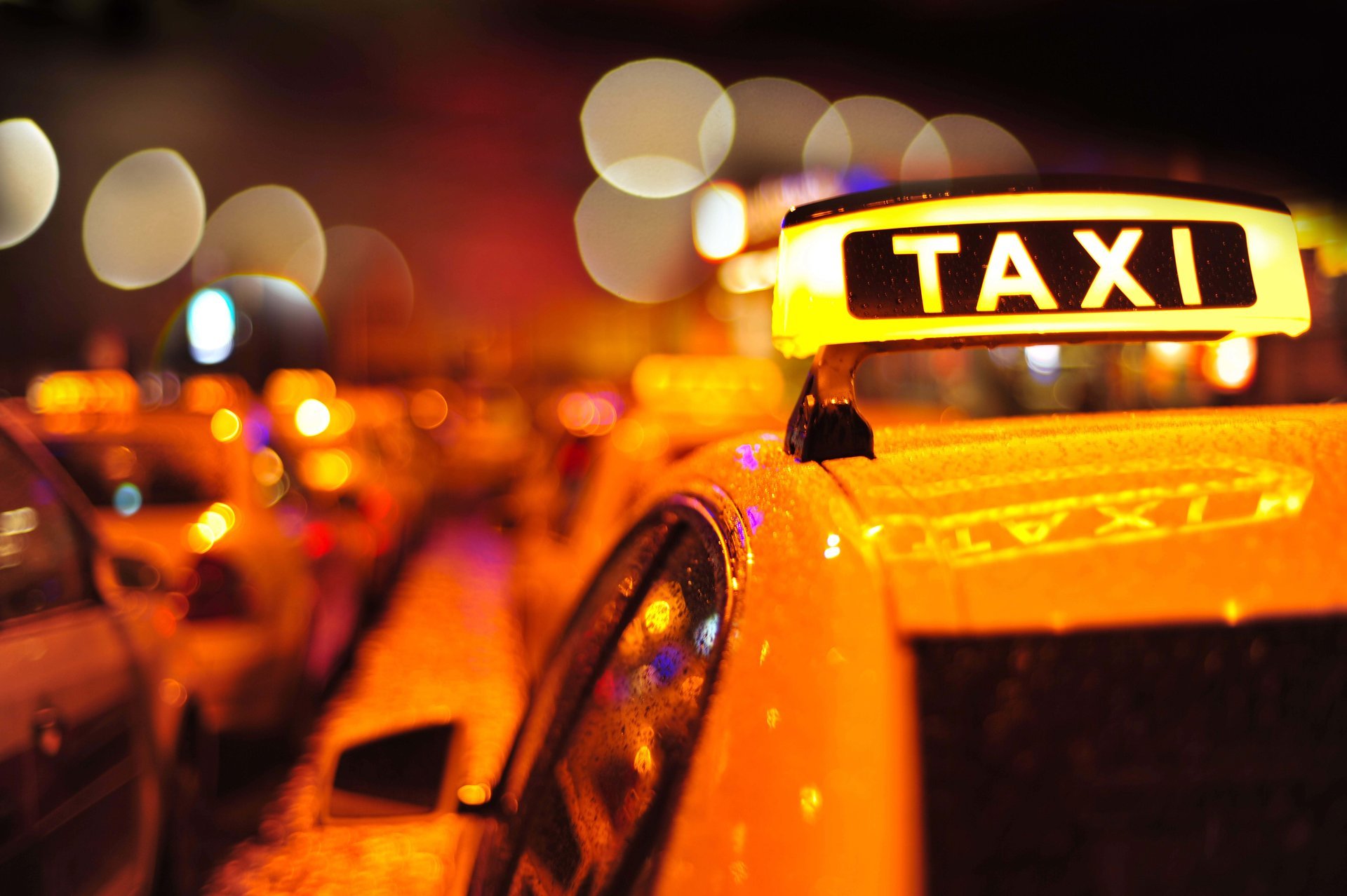 taxi machine roof car plate inscription night town colored lights blur bokeh close up wallpaper