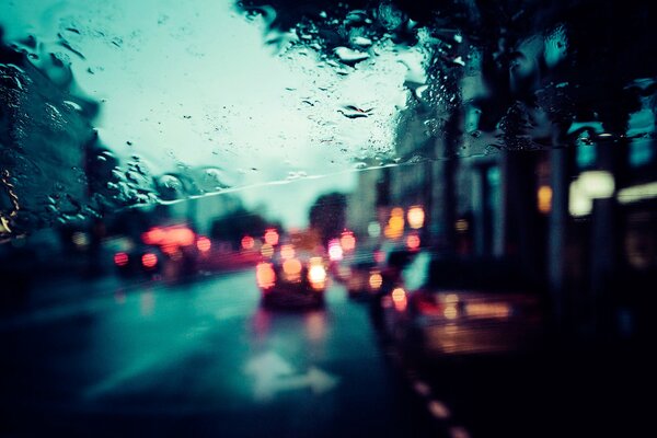 Paris city street in the rain through glass