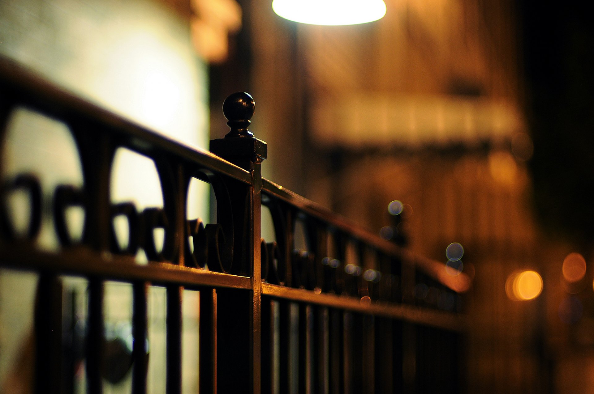 fence metal fence iron rods evening night bokeh lights macro