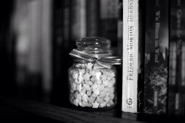 Books with a jar in black and white