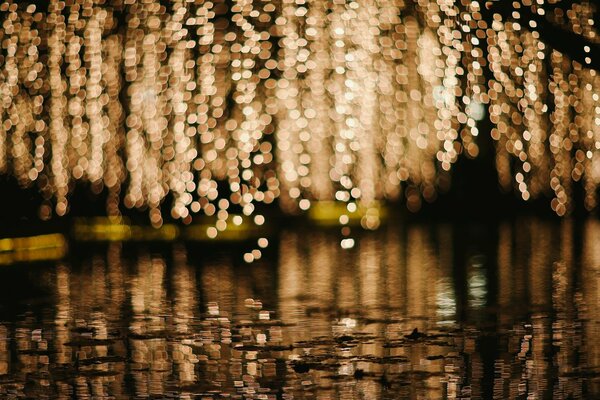 Cascade of yellow lights over the water