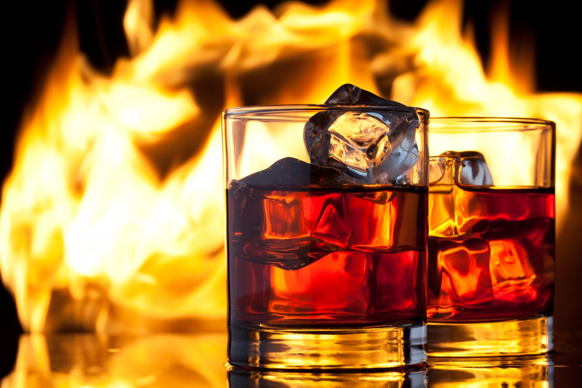 whisky drink next glasses fire flame