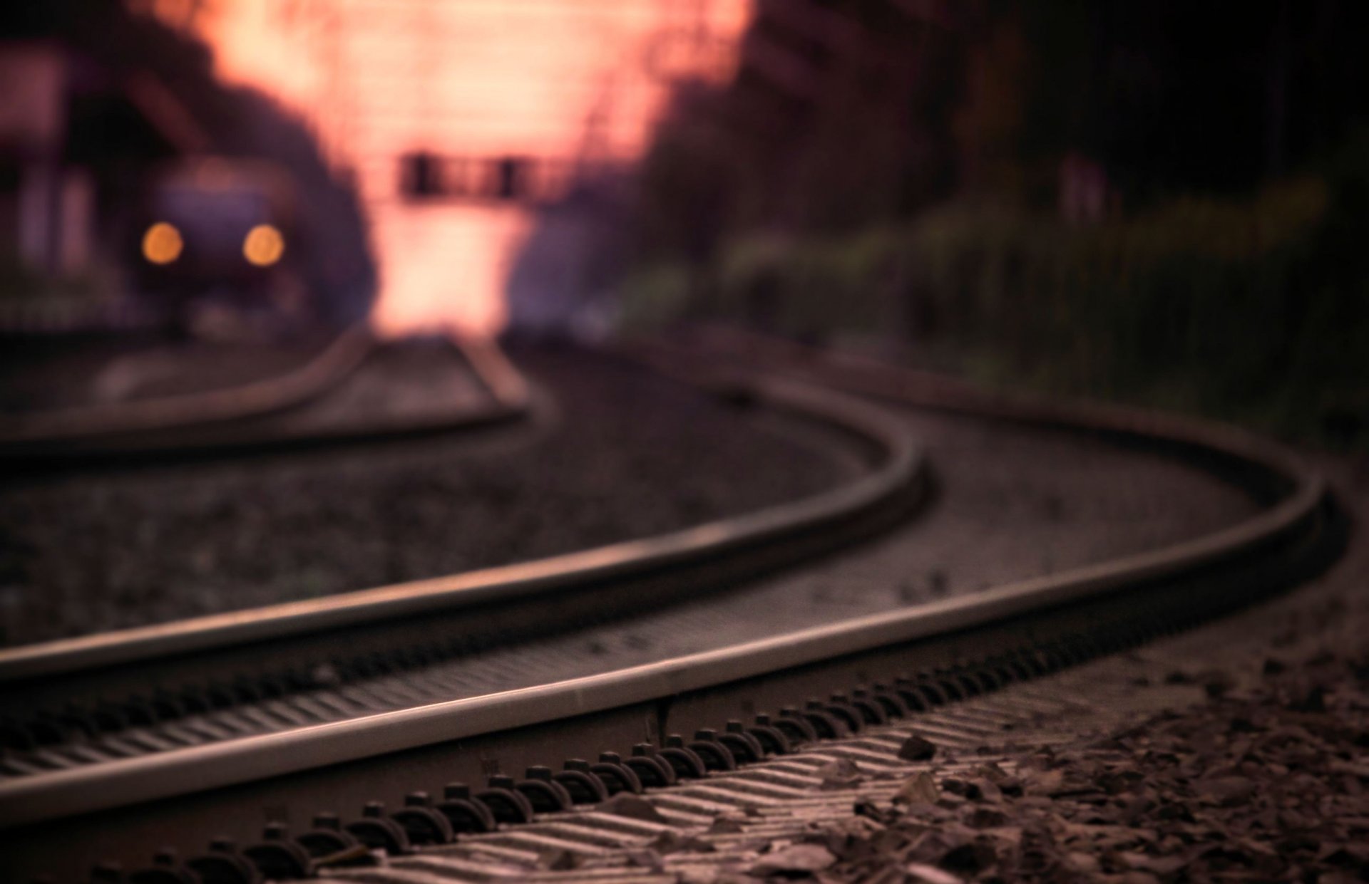 close up photo railroad rails the path sleepers night train lights bokeh blur