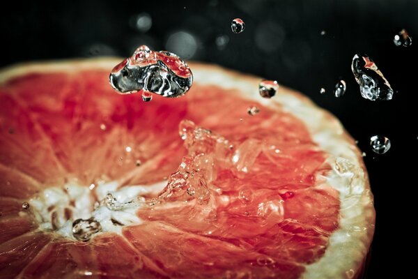 Macro image of water droplets on a grapefruit