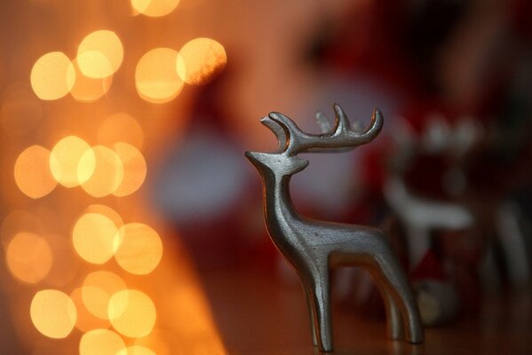 Deer statuette on orange bokeh background